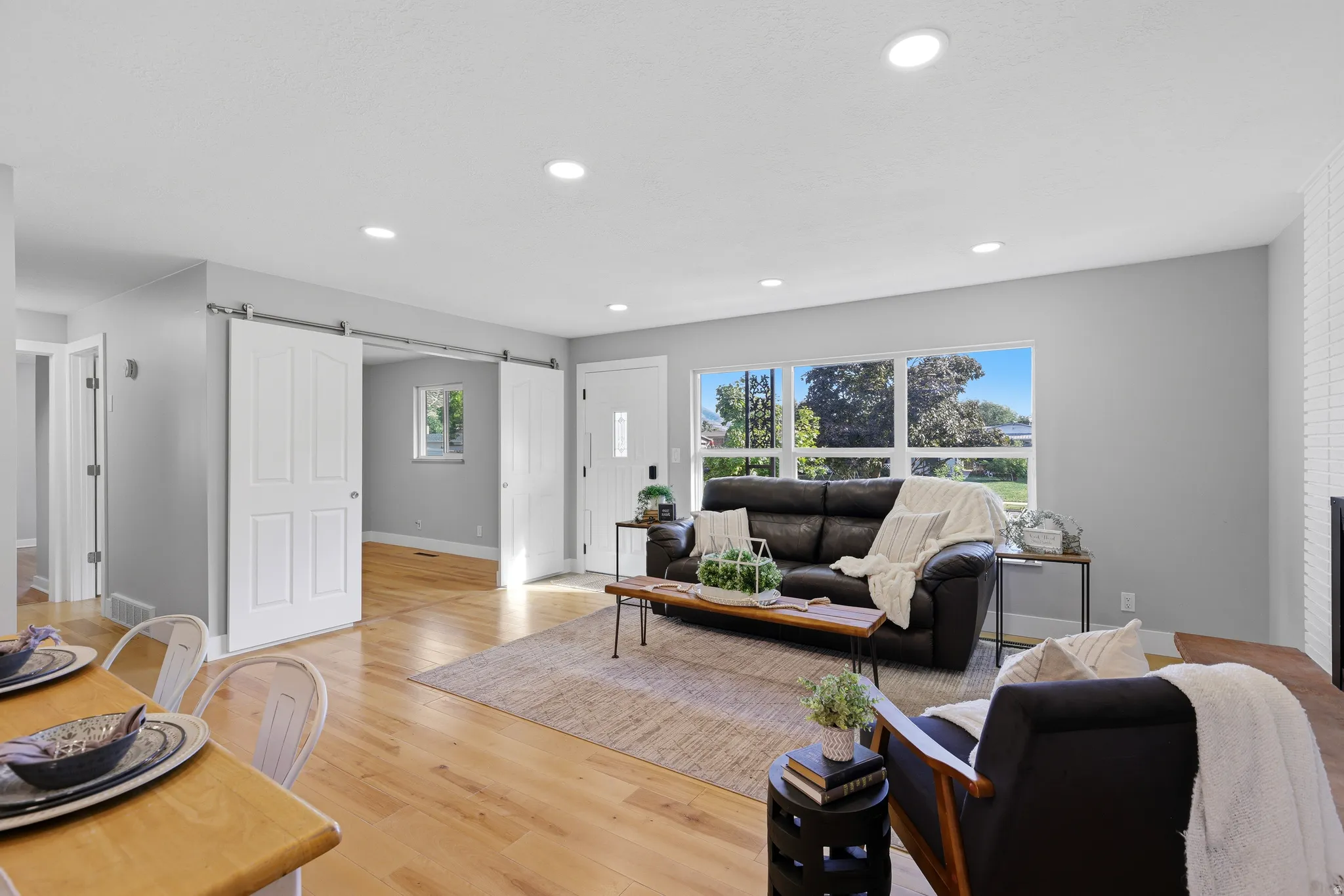 Open floor plan, huge updated windows, hardwood flooring, and fresh neutral paint