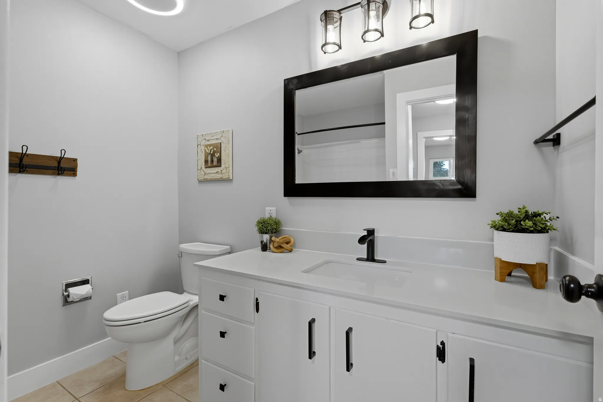 Updated main floor bathroom with large vanity, full sized shower and fresh neutral paint