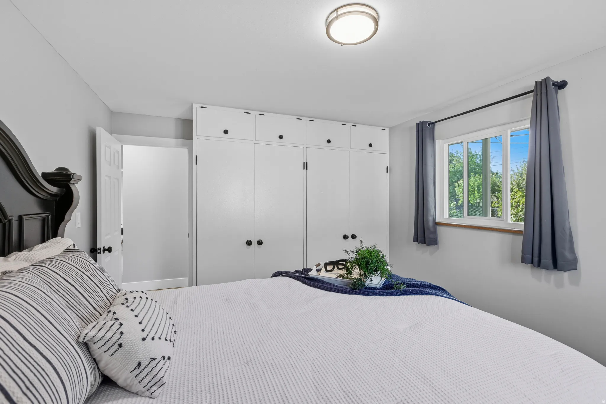 Main level bedroom with double updated windows, large closet, hardwood floors and fresh neutral paint.