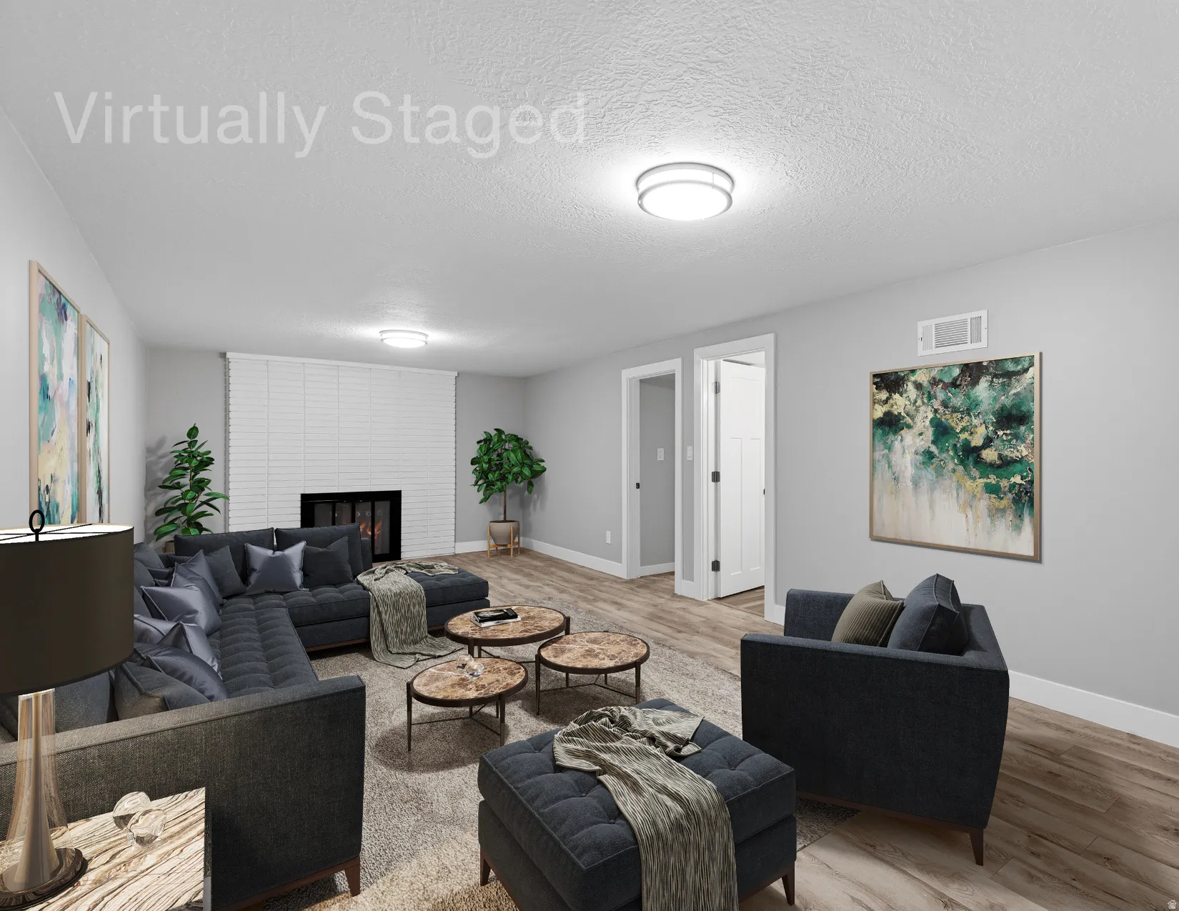 Lower level gathering space with fireplace, laminate flooring, fresh neutral paint and LED lighting.  Virtually staged