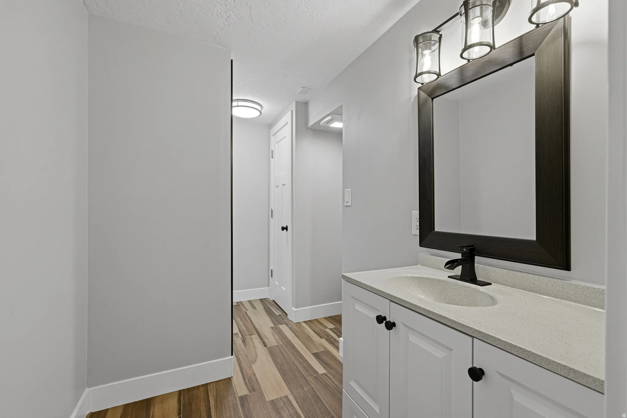 Updated lower level bathroom with large vanity and updated shower
