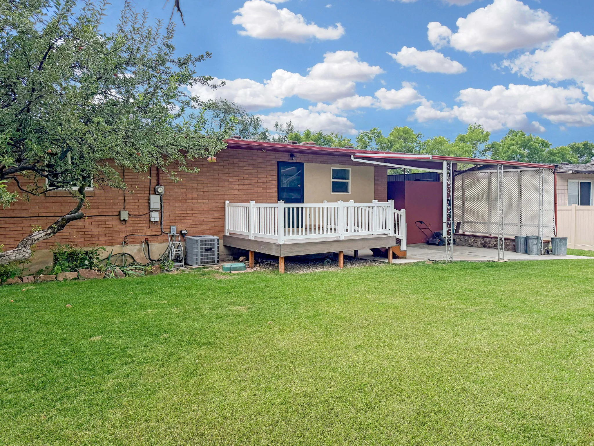 Brand new deck features vinyl railings and engineered wood surface