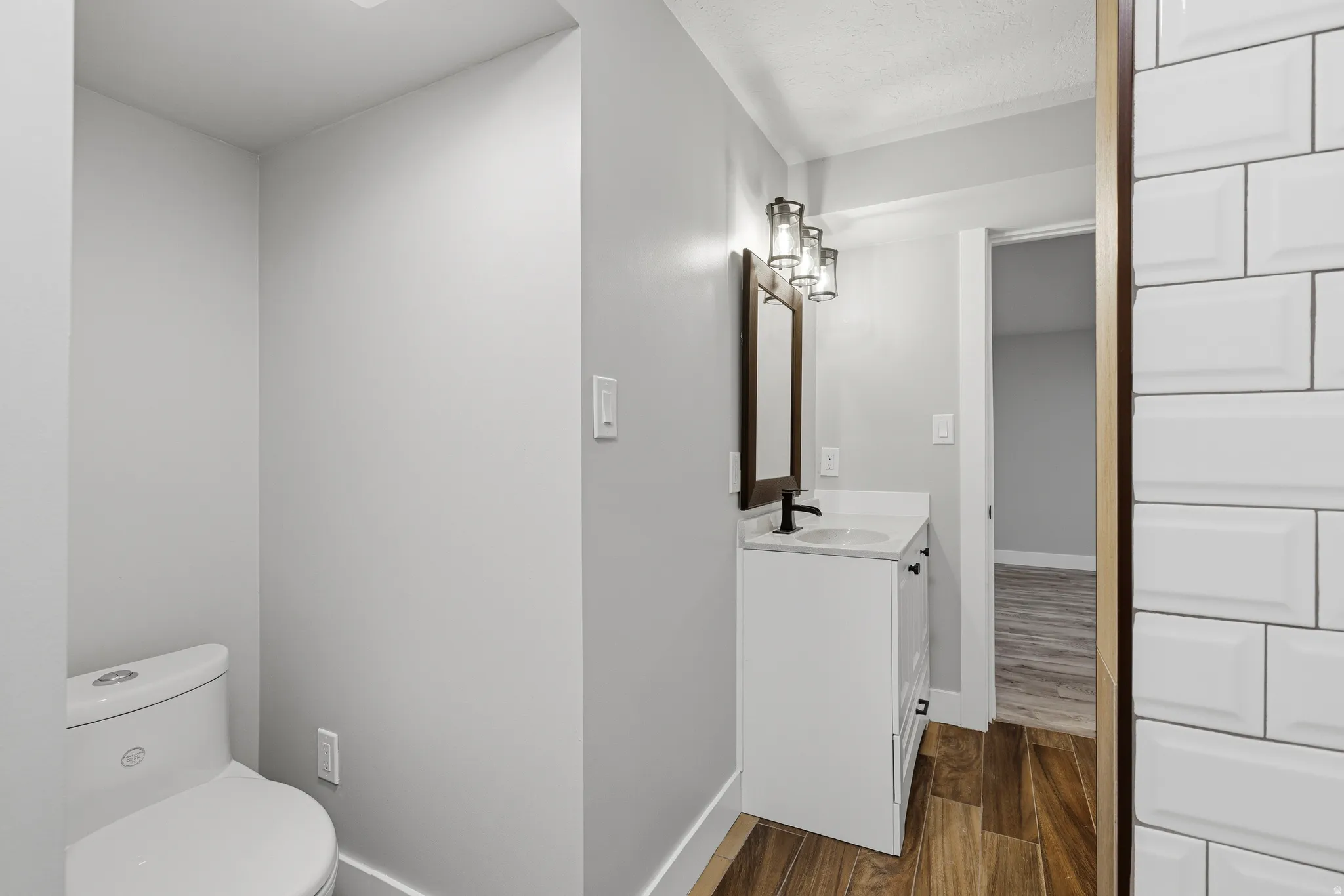 Updated lower level bathroom with large vanity and updated shower