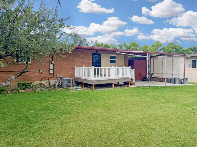 Brand new deck features vinyl railings and engineered wood surface