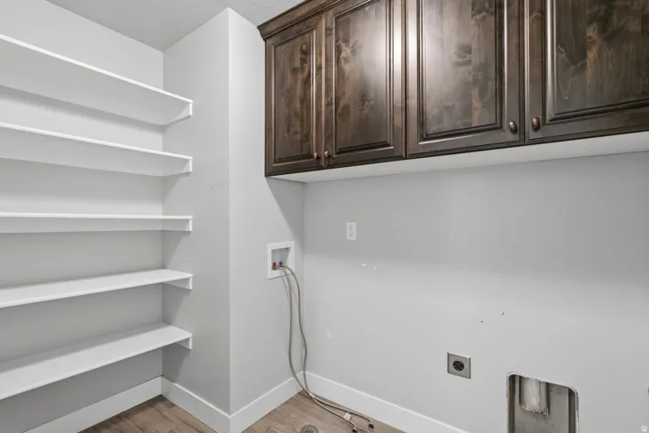 Built-in shelving, wood-finish flooring, and upper cabinetry