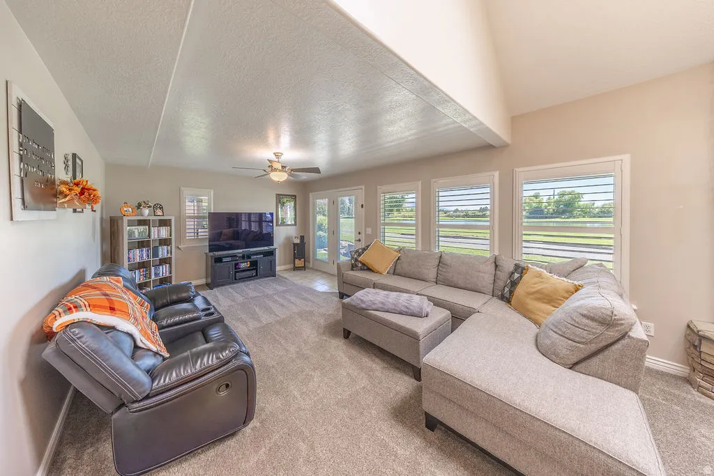 Expansive living area with neutral-toned walls and plush carpeting