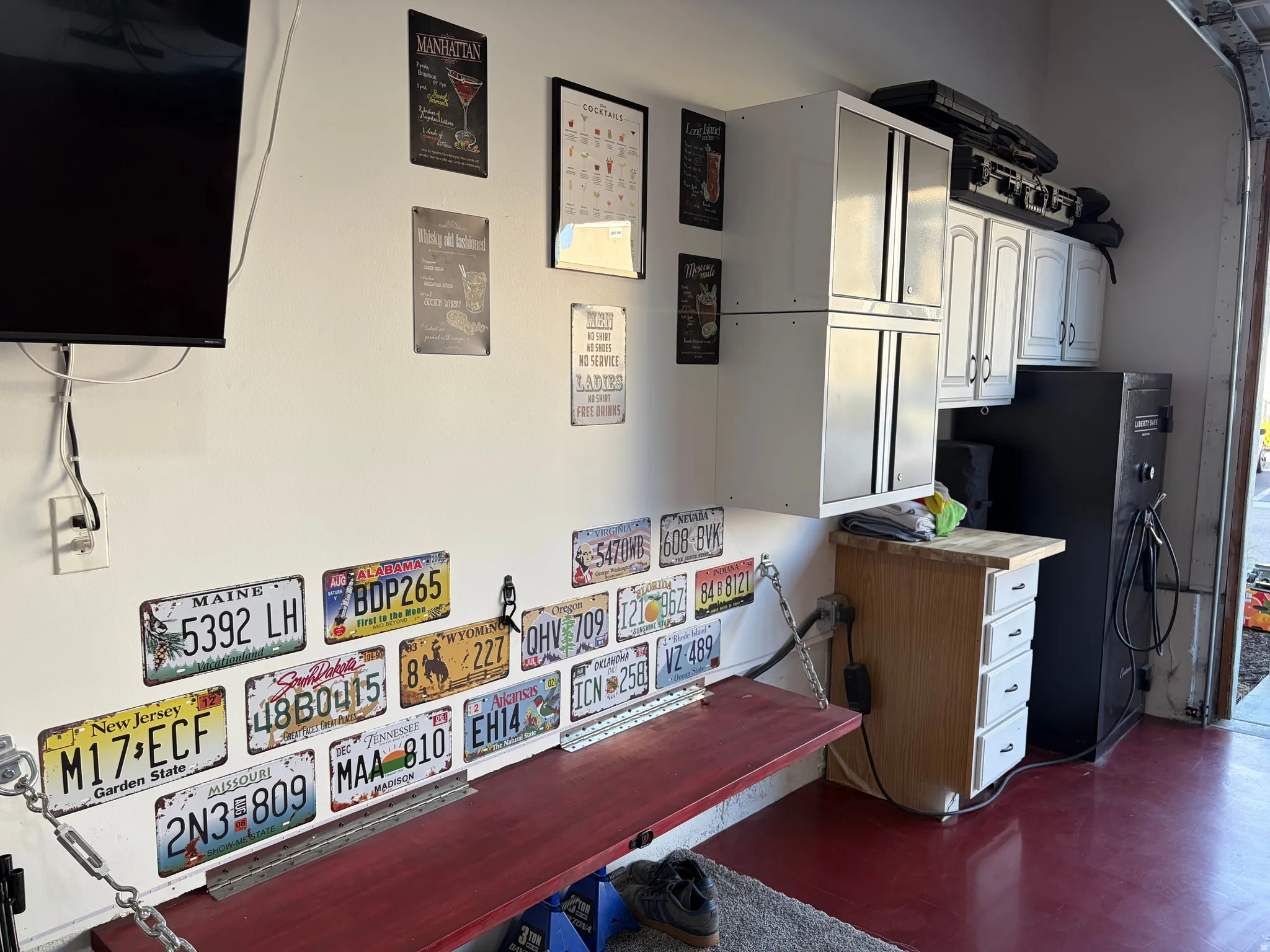 Garage by Day.  Party by Night!  Flip Up Convertible Bar, Mini Fridge, Pac Man Video Arcade Game, 60" TV, Dart Board, Removable Dance/Fitness Pole, Custom Flip Up Bench Seating, Lights, Speakers, Storage Cabinets and Decor, plus an EV Plug and Mounted Ret