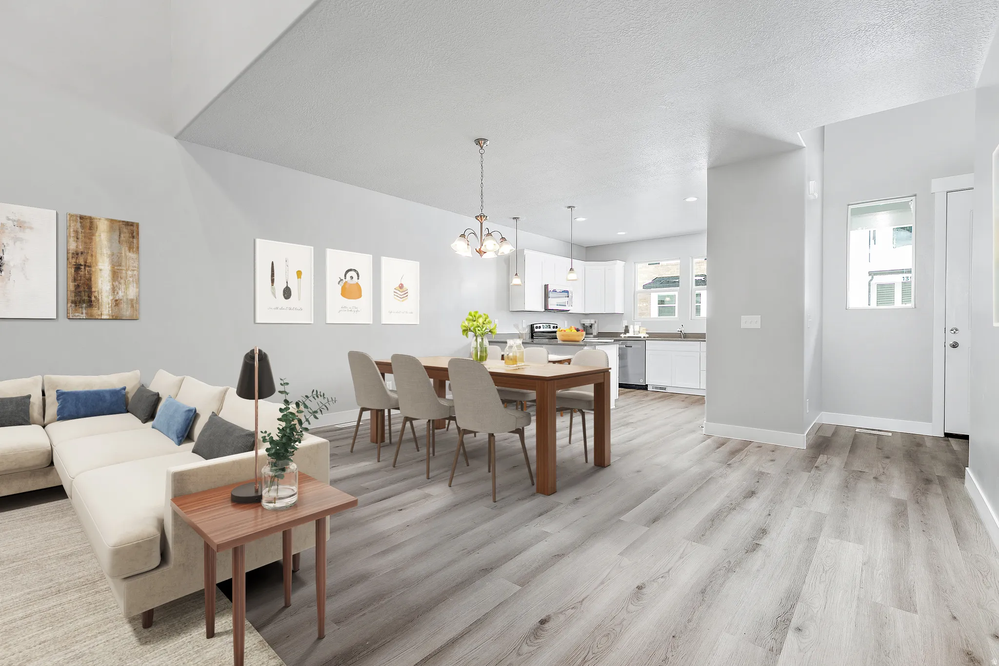 Open-concept living space featuring wood-finish flooring, recessed lighting, and a vaulted ceiling