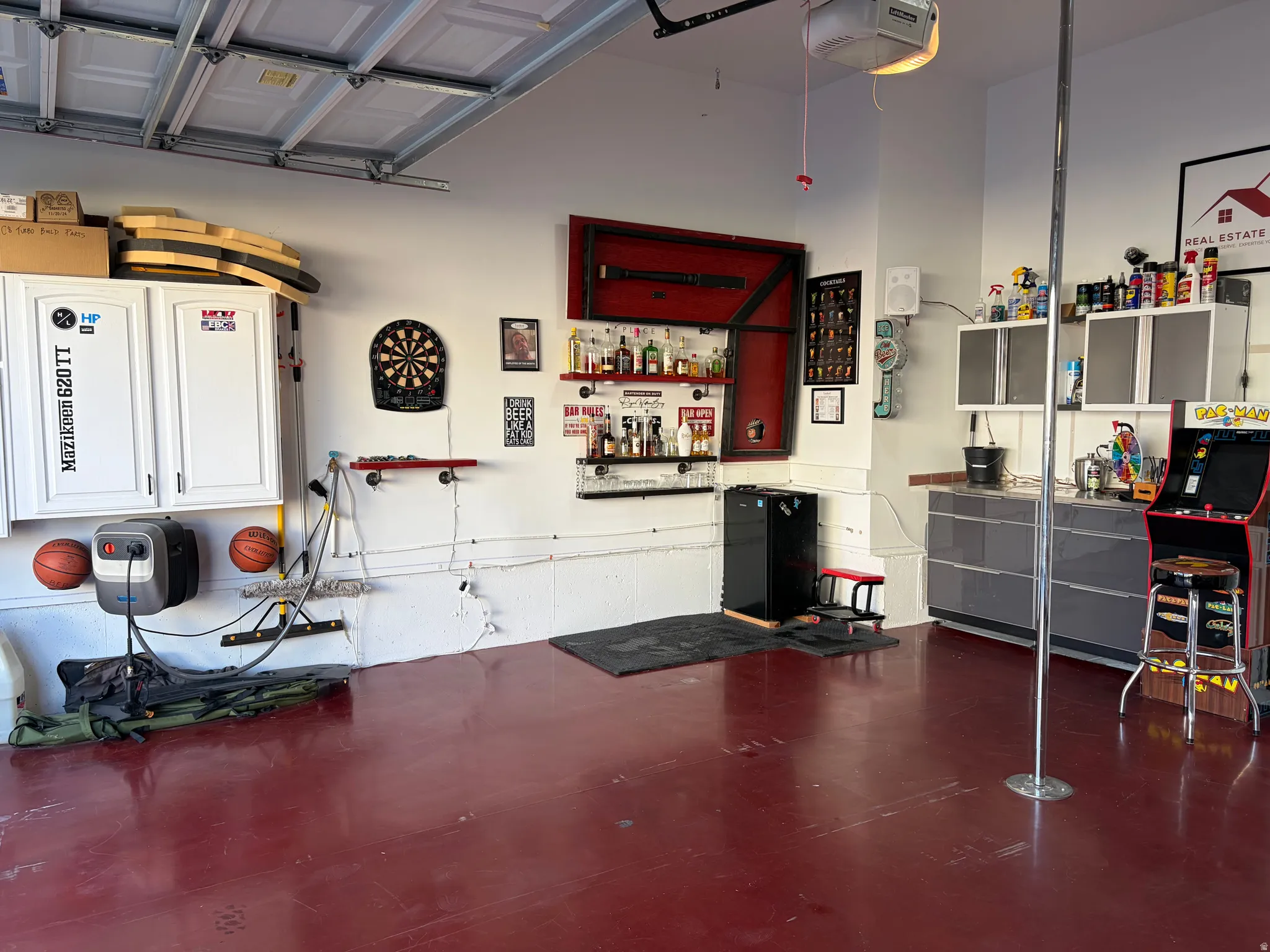 Garage by Day.  Party by Night!  Flip Up Convertible Bar, Mini Fridge, Pac Man Video Arcade Game, 60" TV, Dart Board, Removable Dance/Fitness Pole, Custom Flip Up Bench Seating, Lights, Speakers, Storage Cabinets and Decor, plus an EV Plug and Mounted Ret