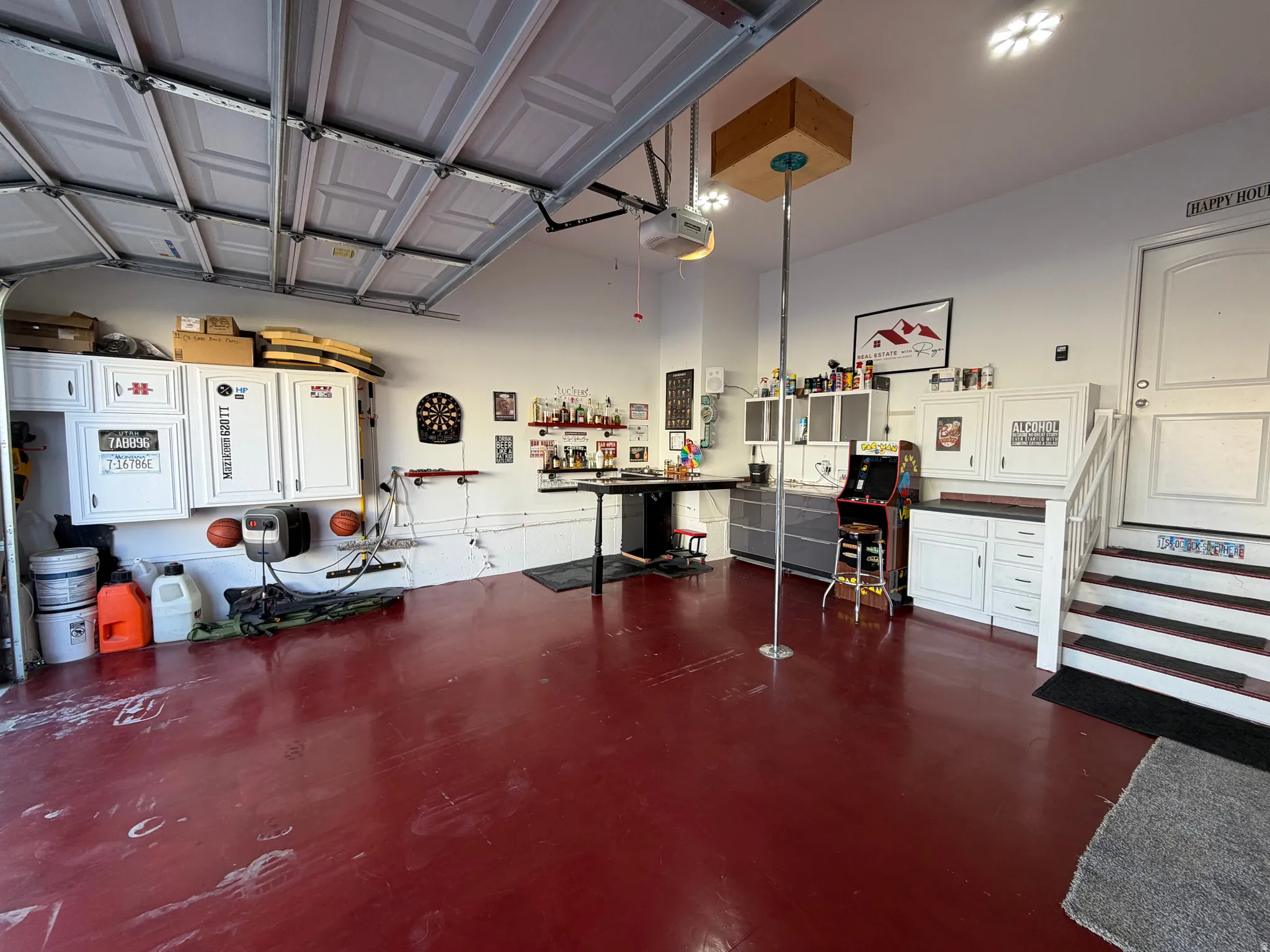 Garage by Day.  Party by Night!  Flip Up Convertible Bar, Mini Fridge, Pac Man Video Arcade Game, 60" TV, Dart Board, Removable Dance/Fitness Pole, Custom Flip Up Bench Seating, Lights, Speakers, Storage Cabinets and Decor, plus an EV Plug and Mounted Ret