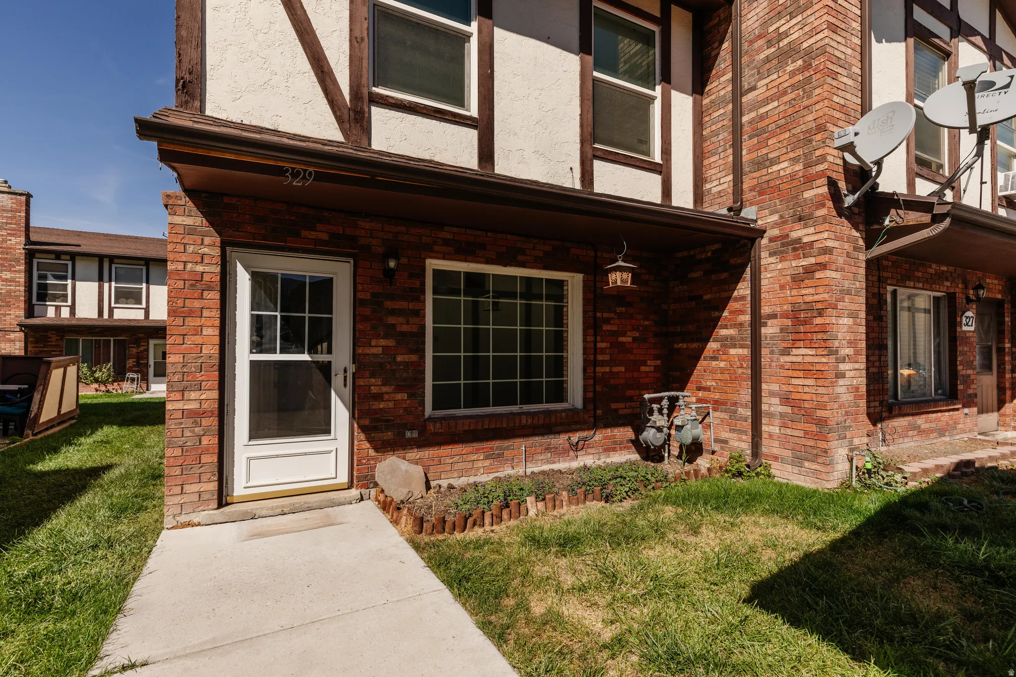 Brick and stucco exterior with dark timber accents