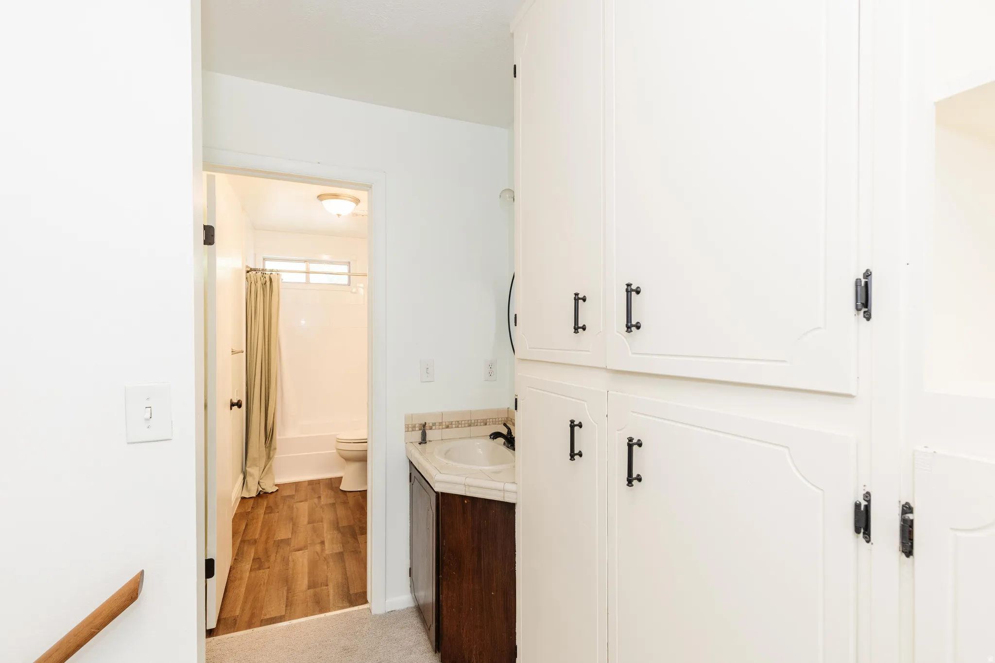 Built-in storage cabinetry with decorative paneling and dark hardware