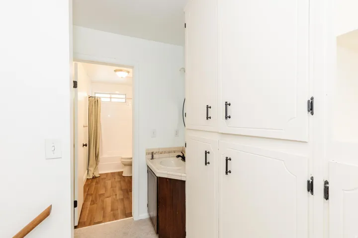 Built-in storage cabinetry with decorative paneling and dark hardware