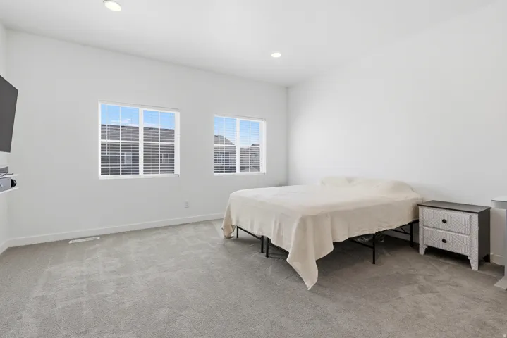 Bright interior space with carpet flooring and recessed lighting