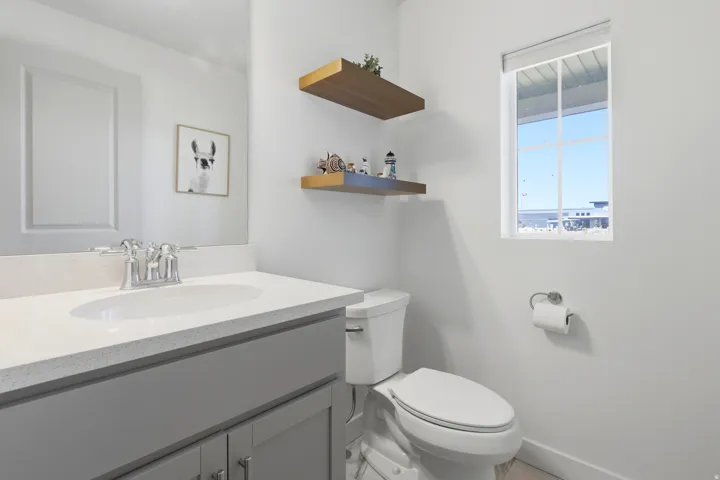 Vanity with a light-toned countertop, undermount sink, and chrome faucet