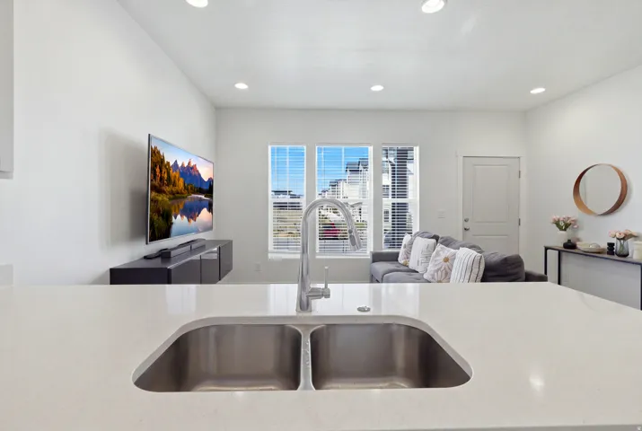 Dual basin stainless steel sink with a high-arch chrome faucet