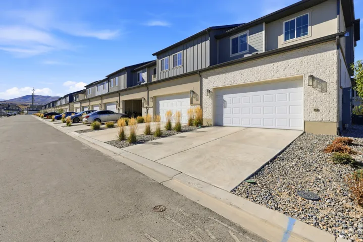 Contemporary exterior with a textured finish, panel siding, and multiple windows