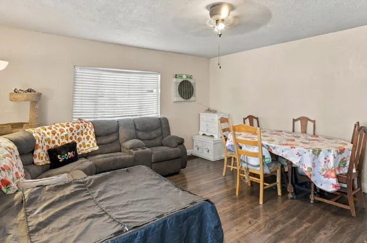 Recessed lighting and a ceiling fan illuminate the space
