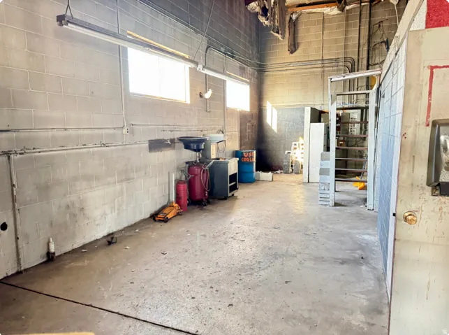 Concrete block walls with multiple windows and exposed overhead lighting