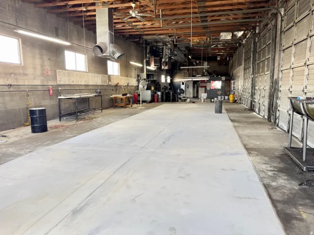 Expansive concrete flooring throughout the interior