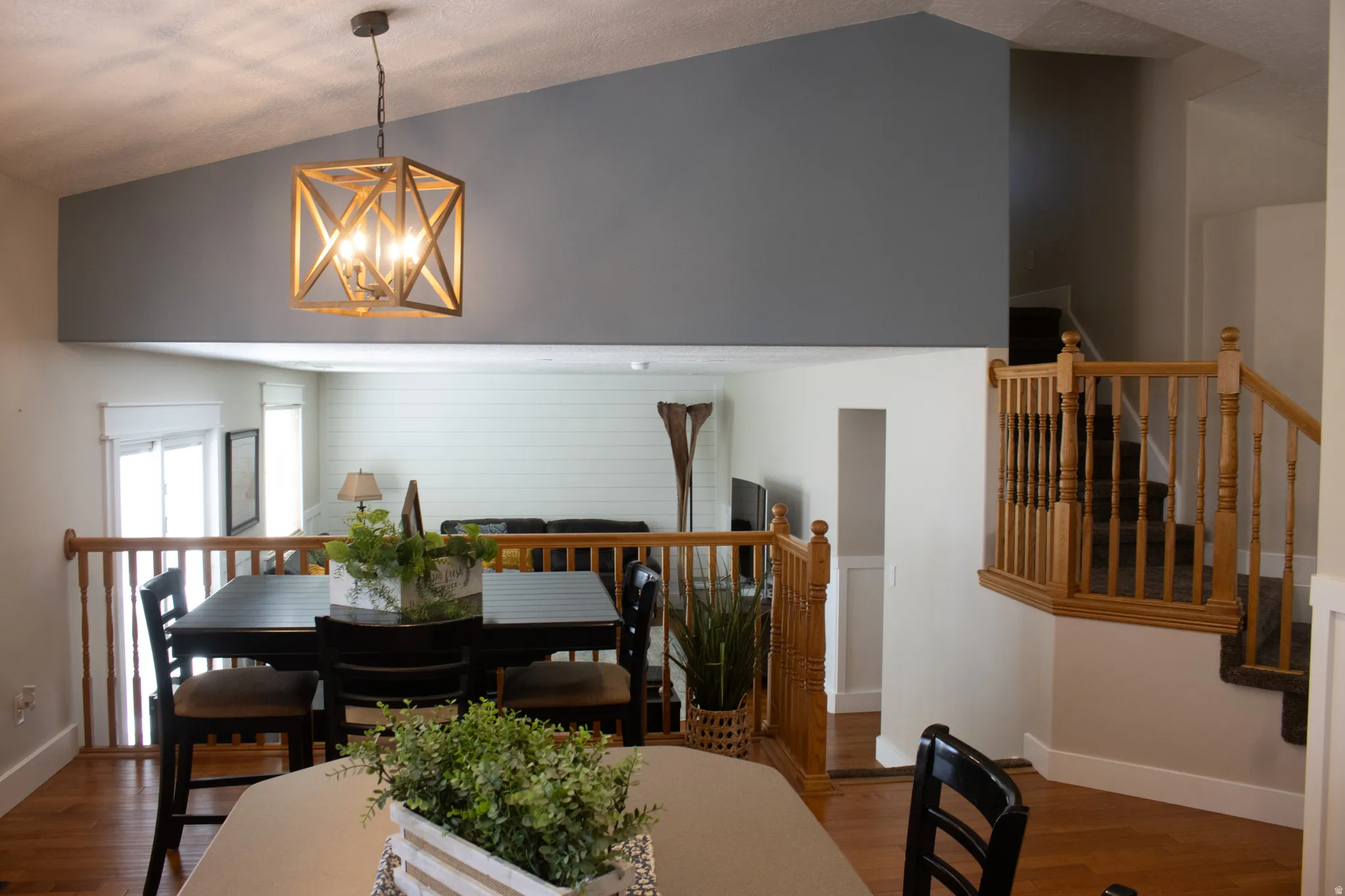 Vaulted ceiling with an open-frame chandelier