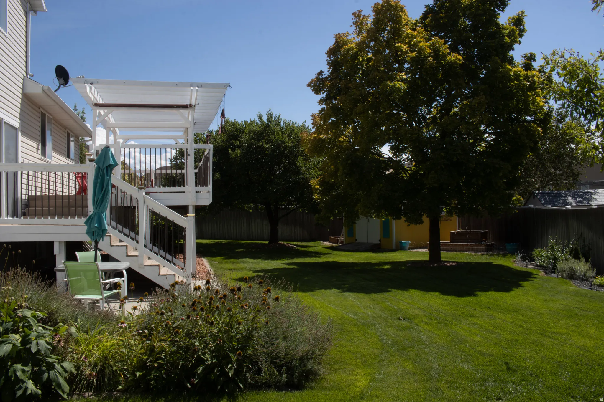 Multi-level deck with a pergola, staircase, and balustrade