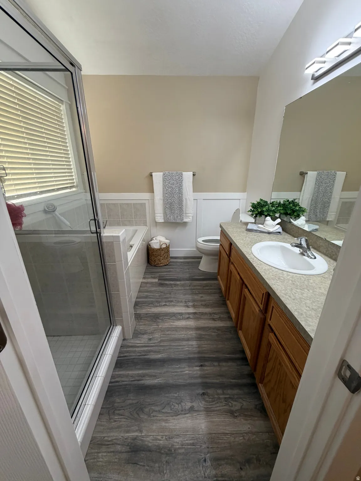 Walk-in shower with clear glass enclosure, tiled shower surround, and a built-in tub