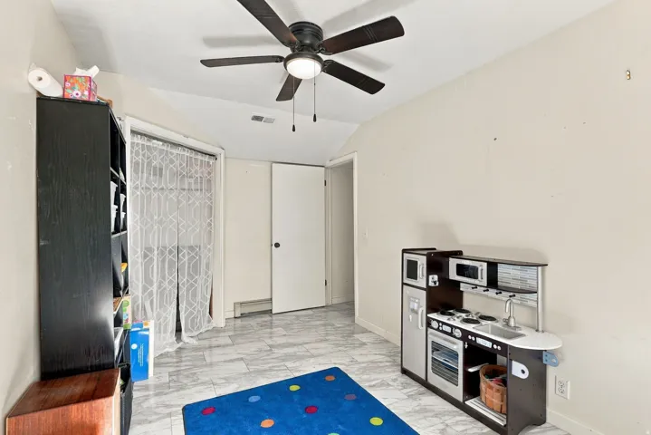 Ceiling fan with integrated lighting, two white panel doors, and tile flooring