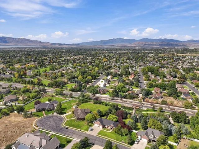 Expansive residential area with mature trees and a mountain backdrop