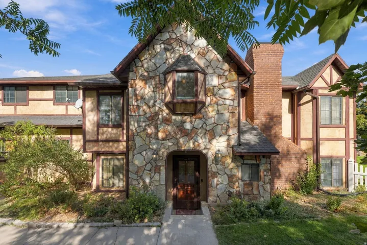 Stone and stucco exterior with exposed timber accents