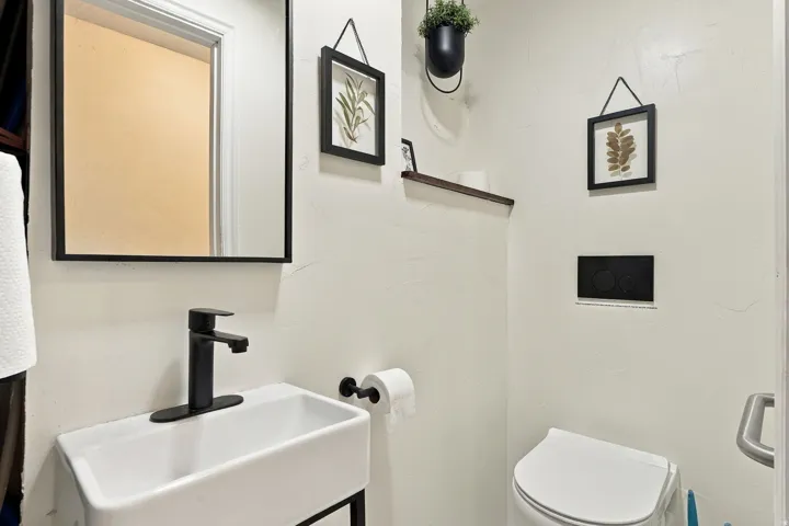 White rectangular vessel sink with a matte black single-handle faucet