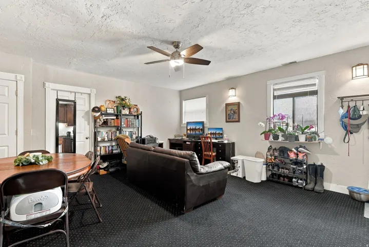 Recessed lighting, ceiling fan, and sconce lighting illuminate the space