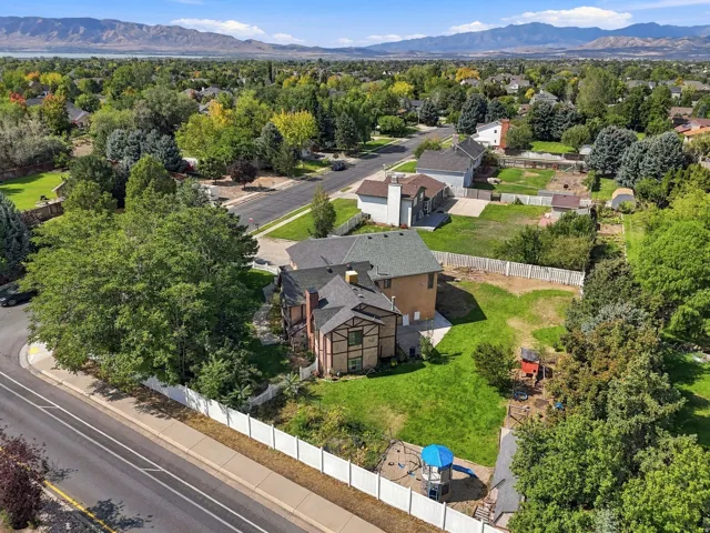 Mature trees, substantial lot, fenced perimeter, paved road access, mountain backdrop
