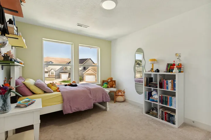 Recessed lighting, light-toned carpeting, and multiple windows