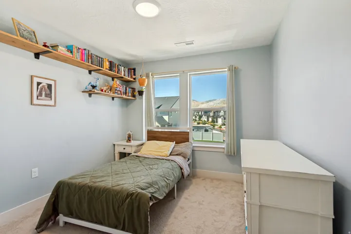 Recessed lighting fixture, light blue walls, and carpeted flooring
