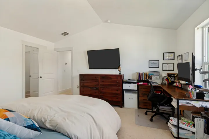Vaulted ceiling, arched doorways, and carpeted flooring