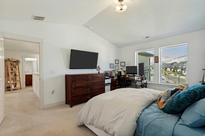 Vaulted ceiling, recessed lighting, and dual windows