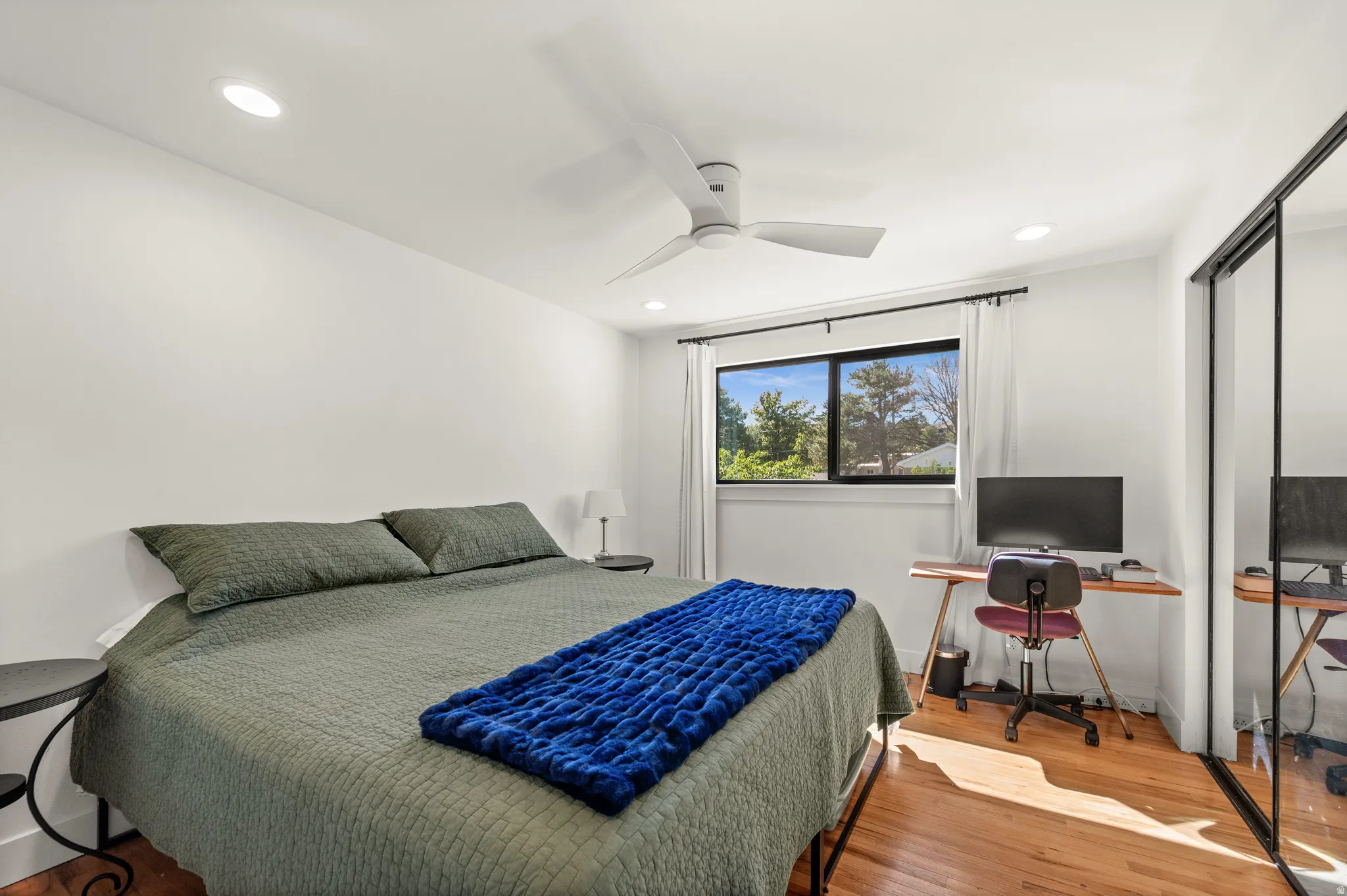 Recessed lighting, ceiling fan, wood-finish flooring, and a large window
