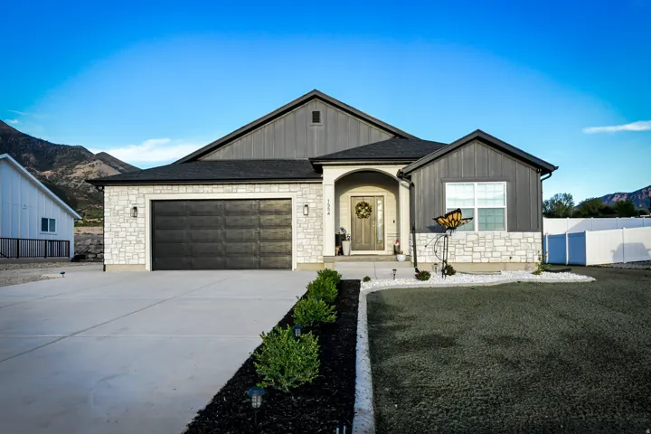 Contemporary exterior featuring stone veneer and vertical siding accents