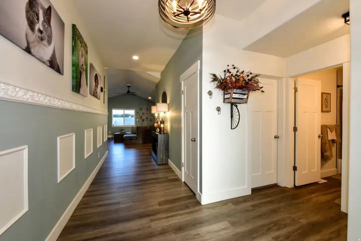 Wood-finish flooring throughout, with a decorative chair rail and paneled wainscoting