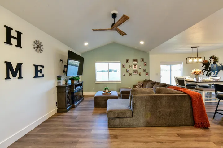 Wood-finish flooring throughout, vaulted ceiling, and recessed lighting