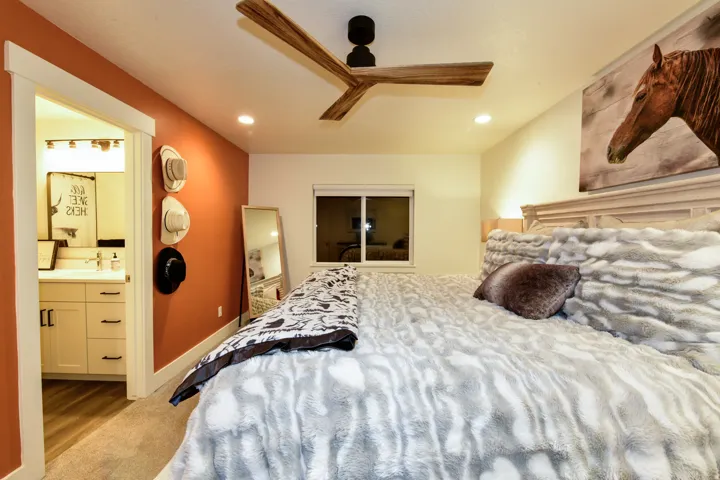 Recessed lighting and a wood-finish ceiling fan illuminate the room