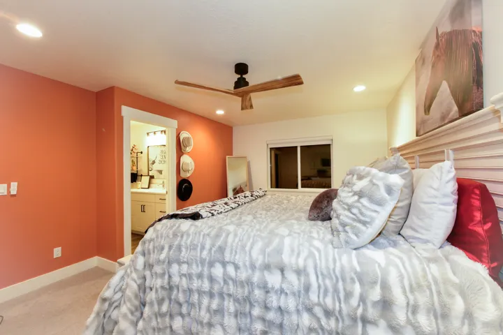 Recessed lighting, wood-finish ceiling fan, and carpeted flooring