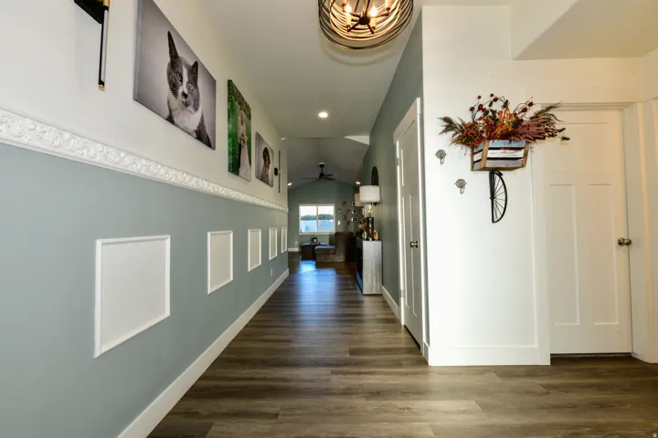 Wood-finish flooring, wainscoting detailing, recessed lighting, and solid core doors