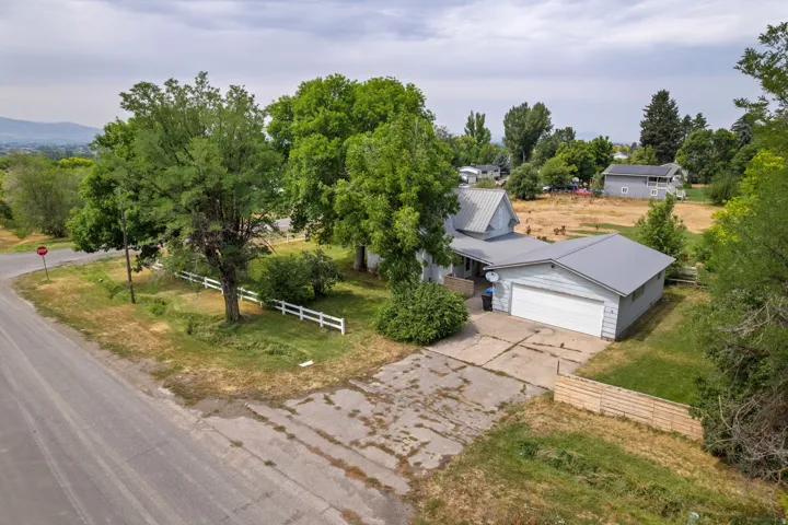 Single-family residence with a metal roof, attached garage, and a concrete driveway