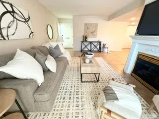 Living area featuring a fireplace with a detailed mantel, tile flooring, and a console table