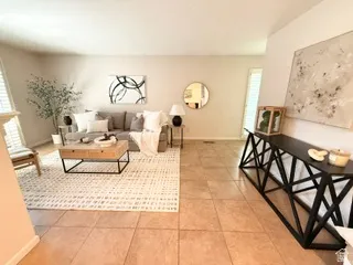 Light-toned walls, tile flooring, and wood-finish flooring