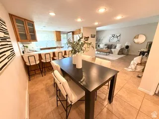 Kitchen featuring wood cabinetry, a breakfast bar, and tile flooring
