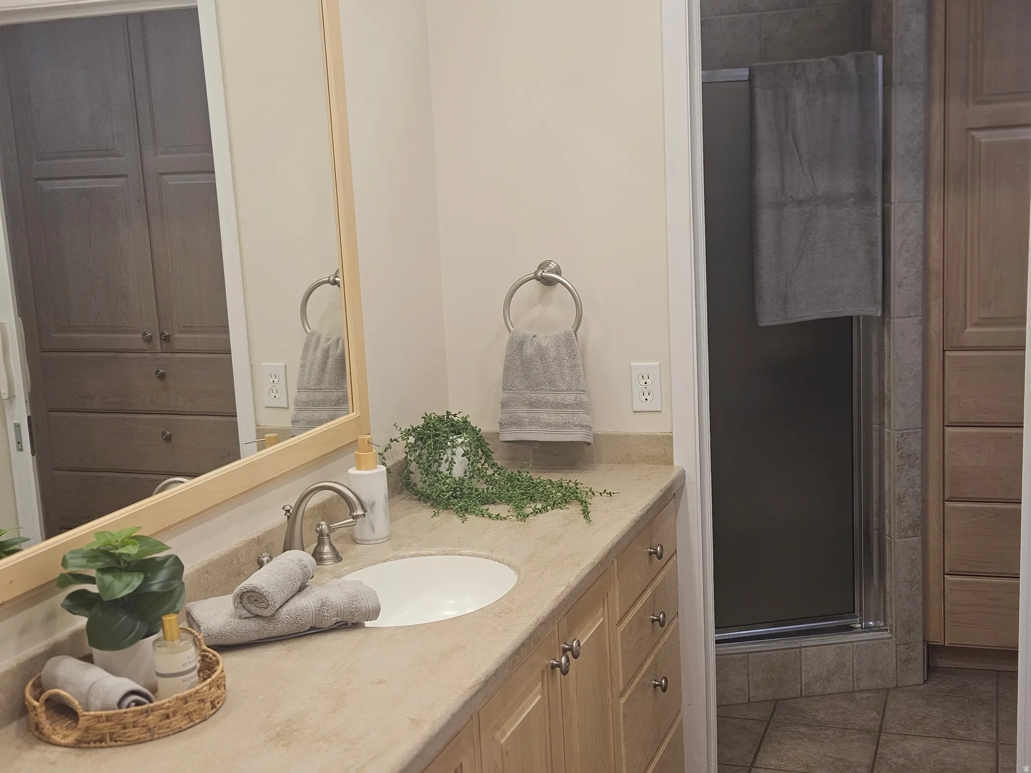 Vanity with an integrated sink, brushed nickel faucet, and a light-colored countertop