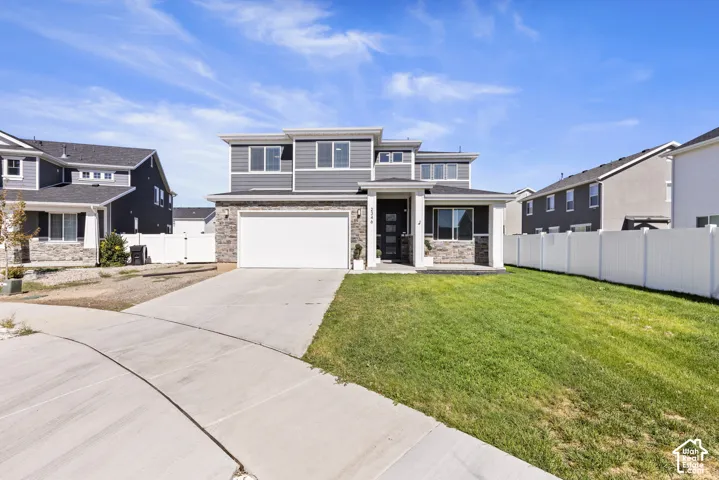 Contemporary exterior with mixed material siding, stone accents, attached two-car garage, and a covered front entry